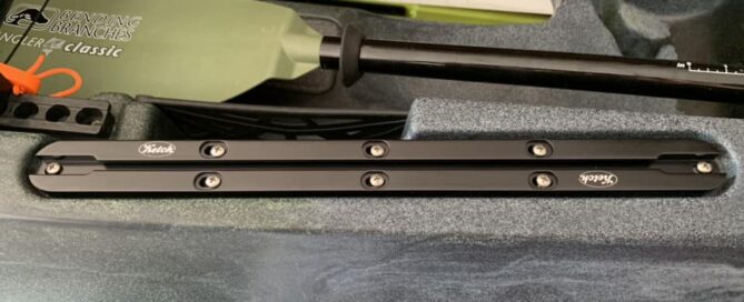 midnight black Ketch OT-1 X-Aktrak installed on an Old Town kayak that is gray and blue.