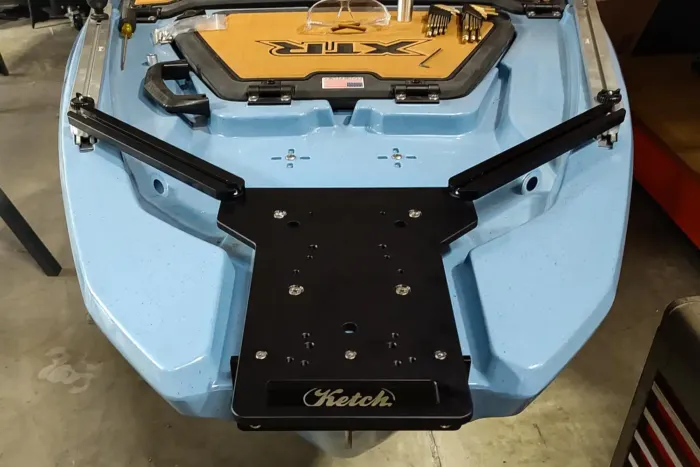 Ketch XTR Bow Motor Mount installed on the bow of a Bonafide XTR130 kayak. The black anodized aluminum mounting plate and support rails are securely attached to the blue kayak, ready for a trolling motor installation.