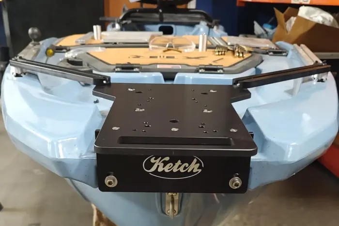 Front view of the Ketch XTR Bow Motor Mount installed on the Bonafide XTR130 kayak. The black anodized aluminum mount with Ketch logo is bolted securely to the blue kayak’s bow, showing the alignment of the support rails and mounting plate.