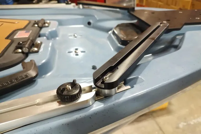 Close-up of the Ketch XTR Bow Motor Mount support rail installed on the Bonafide XTR130 kayak. The anodized aluminum rail is secured to the kayak’s track system with a knob and hardware, showing the precise fit and sturdy construction.